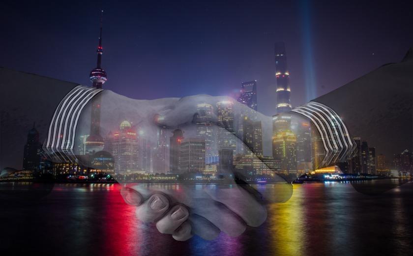 Handshake with Shanghai China skyline