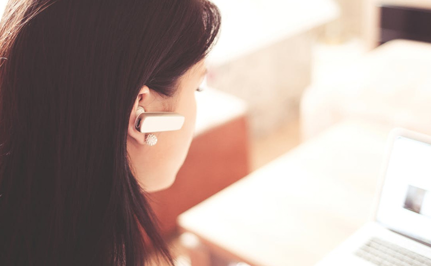 Woman wearing earpiece