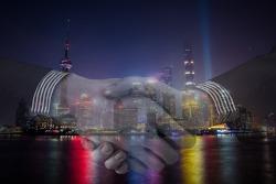 handshake with shanghai china skyline